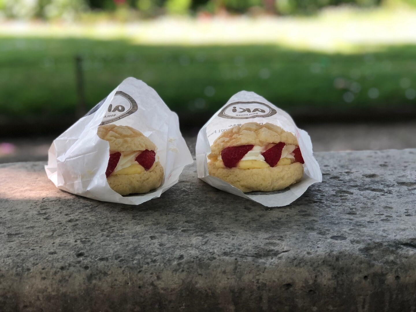 Two melon pan stuffed with cream and strawberries from Aki Mochi Mochi in Paris.
