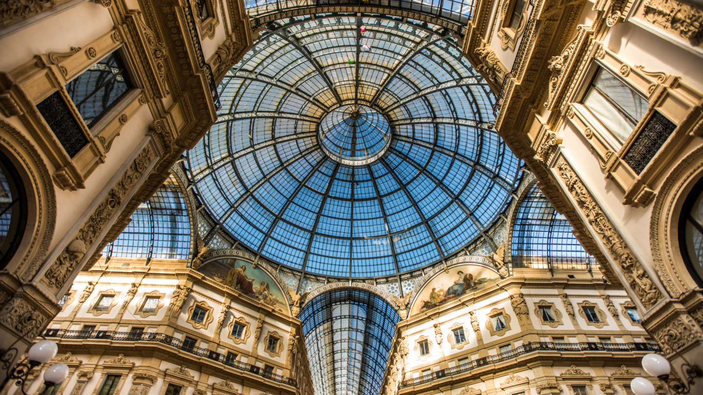 The magnificient glass ceiling and paintings inside of Galleria Vittorio Emanuele II in Milan